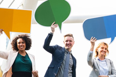 people holding up speech bubbles to communicate