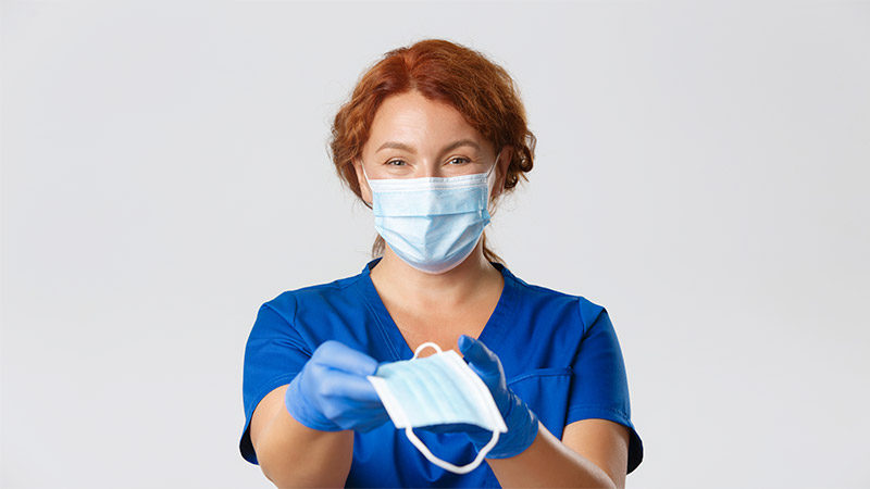 Canadian-Tire-Corporation-launches-5-Million-COVID-19-response-fund Nurse wearing and holding a surgical mask