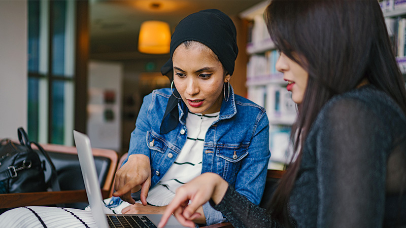 Two women looking at laptop screen