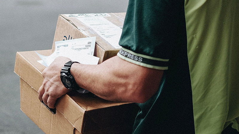 For-Companies Man carrying boxes and mail