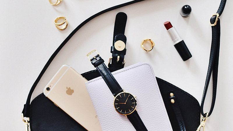 brand-council brand named phone, watch and other jewelry on table