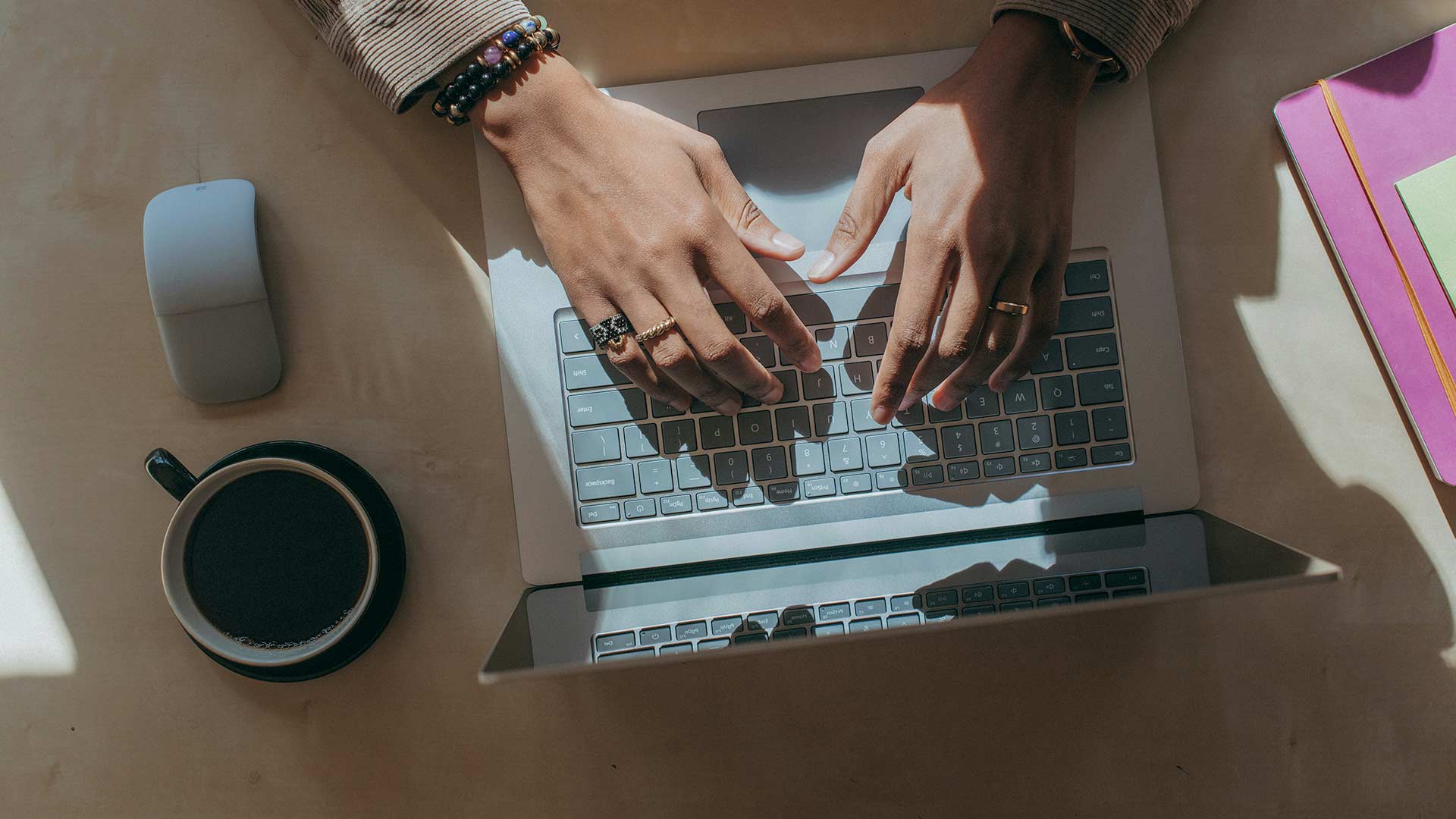Person sitting at desk using laptop computer